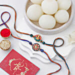 Vibrant Ganesh and Om Rakhi Duo N Sweetness Set