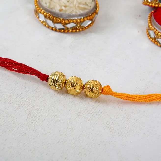 Buy/Send Golden Beaded Rakhi Online- FNP